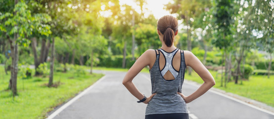 Back view of young fitness woman running on the road in the morning, People and sport concept