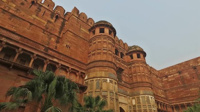 Panning view of the high sandstone walls of the historical Fort of Agra, India - a UNESCO world heritage site 