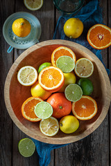 Tasty mix of citrus fruits on old wooden table
