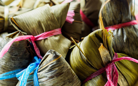 Close-up view of Asian rice dumplings (Zongzi) wrapped in bamboo leaves with copy space