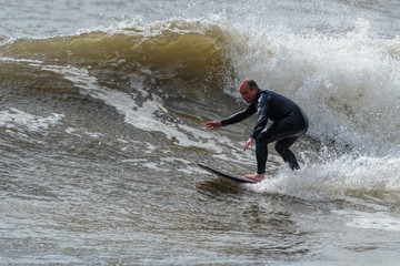 Middle aged surfer shows his style