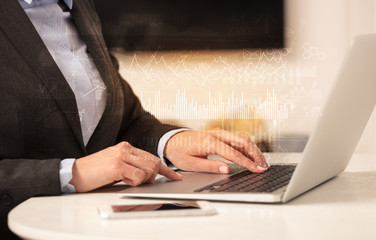 Business woman in homey environment using laptop with global financial report concept
