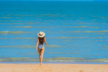 Portrait beautiful young asian woman happy smile relax on the tropical beach sea ocean for leisure travel