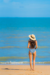 Fototapeta na wymiar Portrait beautiful young asian woman happy smile relax on the tropical beach sea ocean for leisure travel