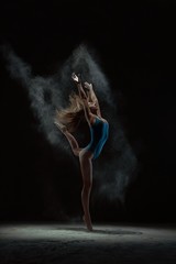 Woman throwing dust and dancing on tiptoes