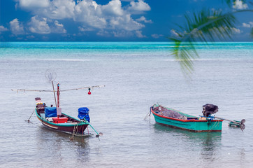 Fototapeta na wymiar Fishing boats anchored at blue lagooon.