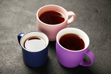 Black tea (coffee) in bright cups, office break, team building.