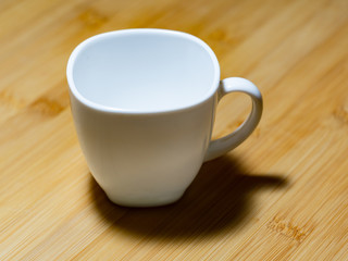 Fototapeta na wymiar White mug on a wooden table