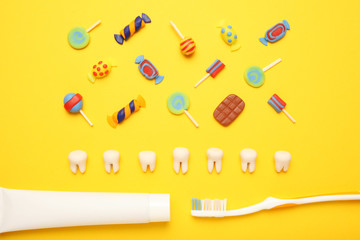 Teeth with sweet candies. Tooth caries in children's, dental healthcare, toothpaste and toothbrush.