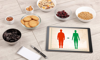 Arrangement of healthy Ingredients with a tablet. Dieting concept