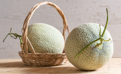 Fresh of whole orange melon or cantaloupe on background wooden table. Favorite fruit in summer concept.