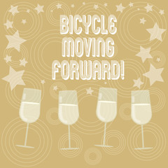 Writing note showing Bicycle Moving Forward. Business photo showcasing To keep your balance, you must keep moving forward Filled Cocktail Wine Glasses with Scattered Stars as Confetti Stemware