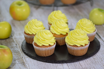 Fresh homemade delicious apple cupcakes with yellow cream