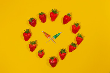 Small umbrellas in a circle of strawberries