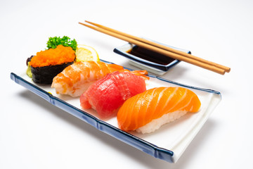 Sushi salmon & tuna sushi shrimp and wasabi on the white plate isolated.selective focus