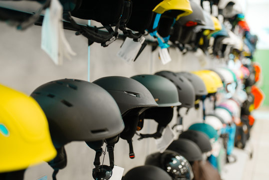 Rows of ski and snowboarding helmets, sports shop