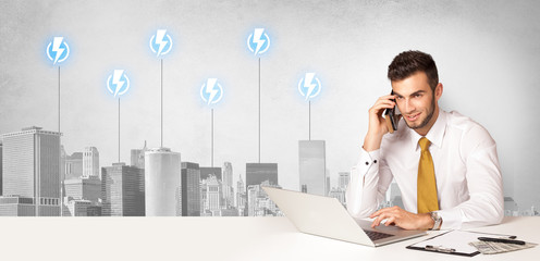 Announcer sitting at desk presenting the city energy consumption
