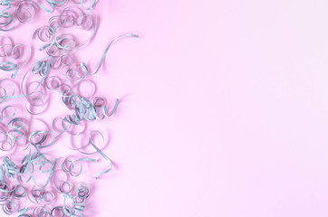 Pink background with silver curls and space for text.