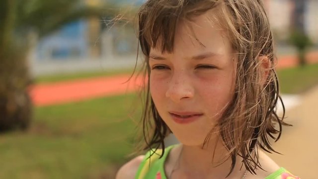 teen girl goes to the seaside from the beach after swimming