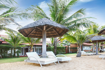 Fototapeta na wymiar Relaxation area watching the sea at resort on the beach in Phu Quoc island in Vietnam. Blue sky. Beautifull sunny