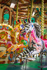 Fototapeta na wymiar Decorated wooden animals on carousel attraction