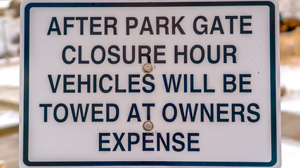 Panorama Close up of a sign at a park blanketed with snow during winter