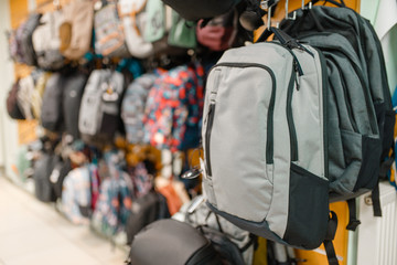 Showcase with backpacks in sports shop, nobody