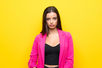 Fototapeta premium Young woman over isolated yellow background with sad and depressed expression