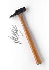used hammer with nails isolated and shaded on white background