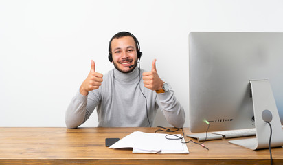 Telemarketer Colombian man with thumbs up gesture and smiling