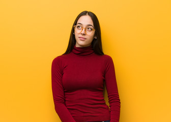 Fototapeta premium Intellectual young girl dreaming of achieving goals and purposes