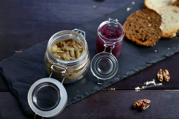 pate with pumpkin seeds and walnuts in a glass jar