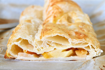 Apple strudel with pastry and a piece of apricot.