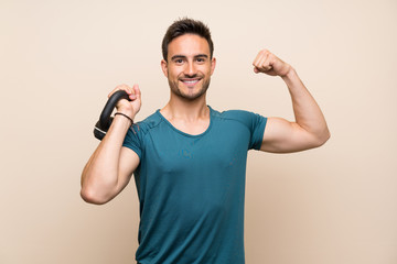 Handsome sport man over isolated background with kettlebell