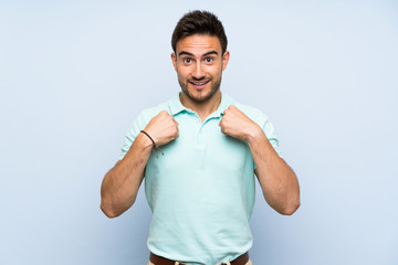 Handsome young man over isolated background with surprise facial expression