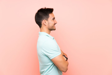 Handsome young man over isolated background in lateral position