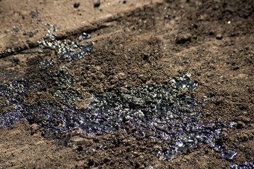 Dirty bitumen on the surface of asphalt under construction