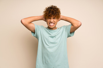 African american man with green shirt frustrated and takes hands on head