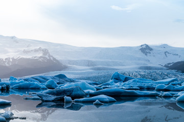 Glacier lake with icebergs with mountain and glacier in the background in Fjalls&aacute;rl&oacute;n, Iceland
