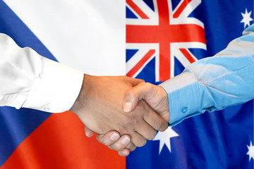 Business handshake on the background of two flags. Men handshake on the background of the Czech Republic and Australia flag. Support concept