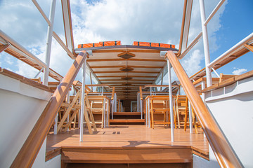 The interior of the urban river ship, with a panoramic view of the urban landscape. The concept of tourism, recreation, walking around the city, rest in the city. River transport.