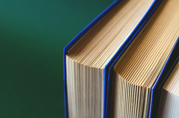 Flat lay of several books on a khaki background.