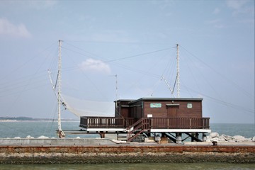 Fototapeta na wymiar fishermen's houses on the sea canal 