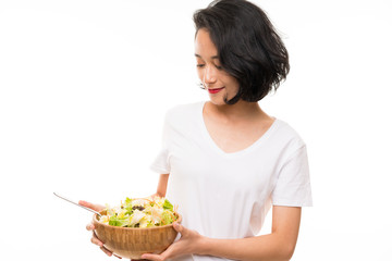 Asian young woman over isolated background with salad