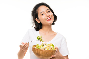 Asian young woman over isolated background with salad