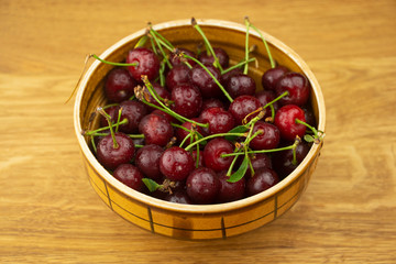 Ripe, red cherry on a wooden table