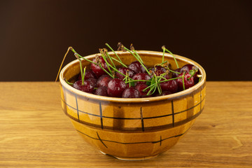 Ripe, red cherry on a wooden table
