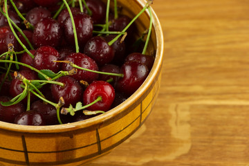 Ripe, red cherry on a wooden table