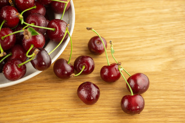 Ripe, red cherry on a wooden table