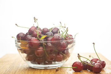 Ripe, red cherry on a wooden table